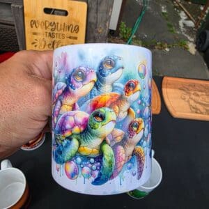 Hand holding vibrant turtle-themed mug
