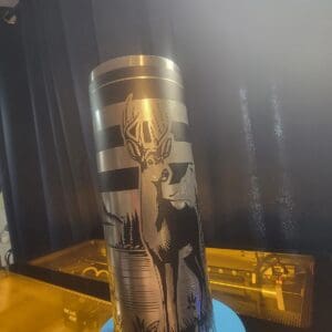Metal tumbler with deer engraving