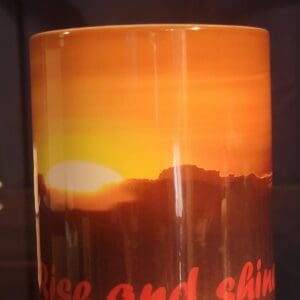 Coffee mug featuring sunrise scene