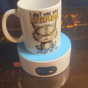Cat-themed mug on a cup warmer