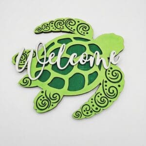 Green turtle-shaped welcome sign with patterns.
