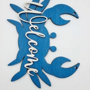 Blue crab-shaped welcome sign on wall.
