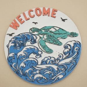 Welcome sign with turtle and ocean waves.