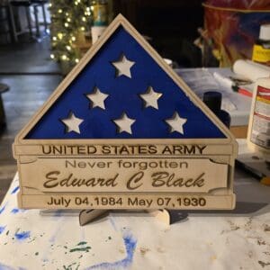 Wooden military memorial plaque with stars.