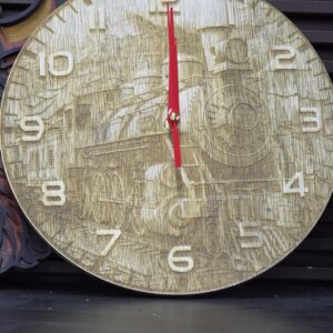 Vintage clock with train design on face.