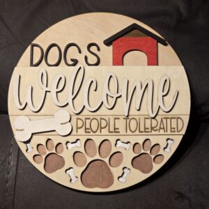Round sign: "Dogs welcome, people tolerated.